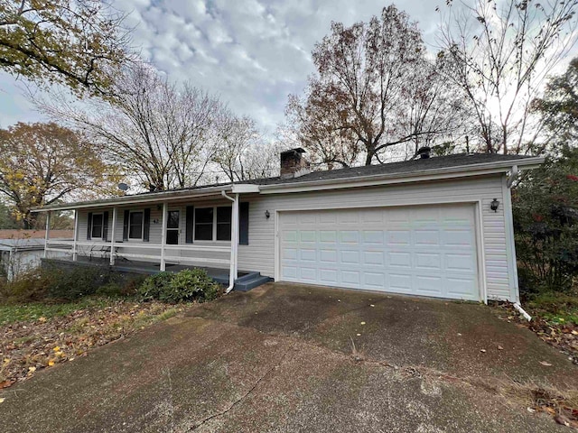 view of front of house featuring a porch and a garage