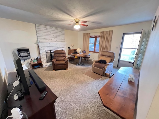 living room featuring a multi sided fireplace, ceiling fan, carpet, and a textured ceiling