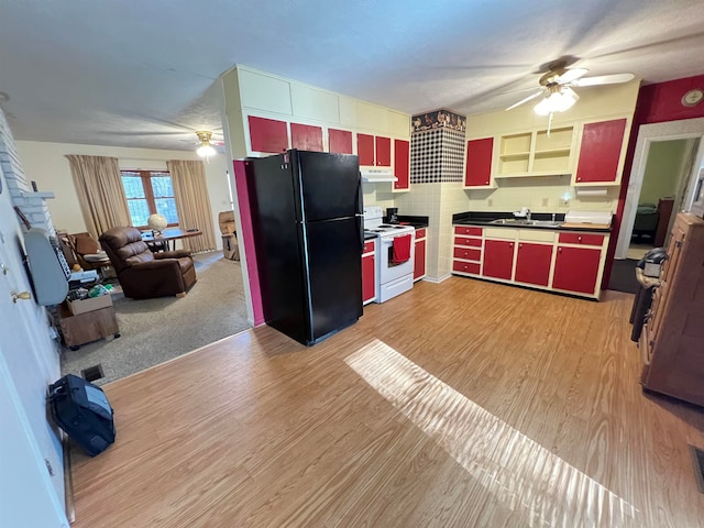 kitchen with black refrigerator, light hardwood / wood-style floors, white electric stove, and sink