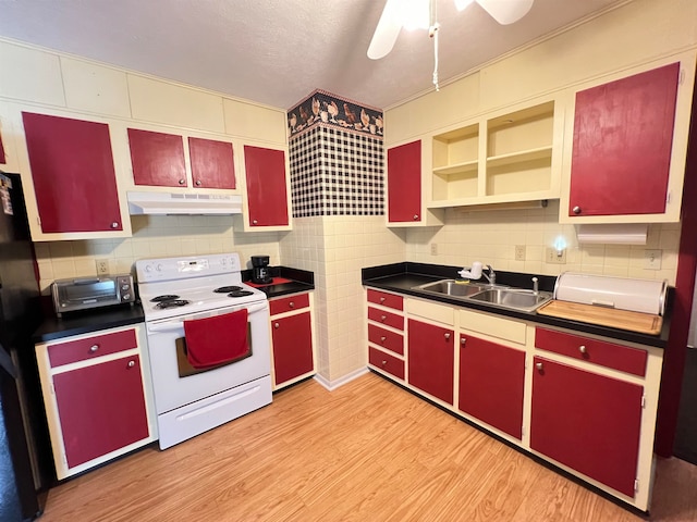 kitchen with black refrigerator, white electric range, sink, light hardwood / wood-style flooring, and decorative backsplash