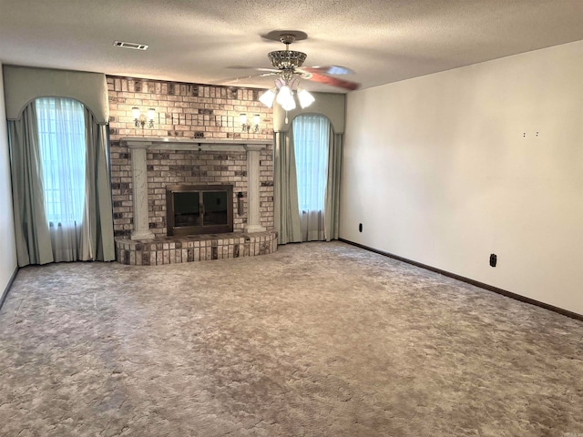 unfurnished living room with carpet flooring, a brick fireplace, and ceiling fan