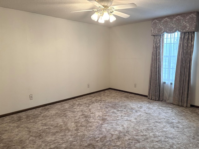 unfurnished room featuring carpet, ceiling fan, and a textured ceiling