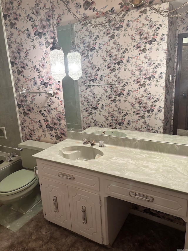 bathroom featuring vanity and toilet