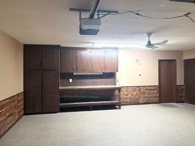 kitchen with ceiling fan, carpet floors, and a textured ceiling