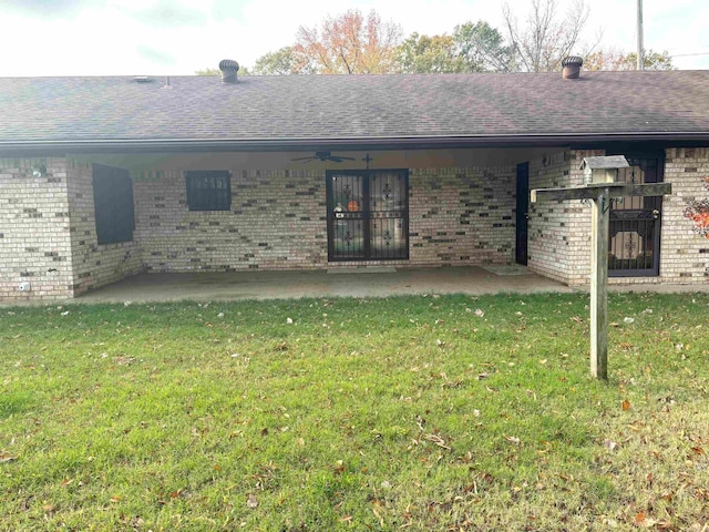 back of house featuring a patio area and a lawn