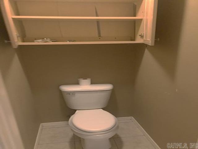 bathroom featuring tile patterned flooring and toilet