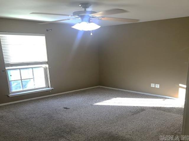 unfurnished room featuring carpet and ceiling fan