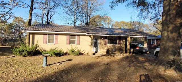 ranch-style house featuring a carport