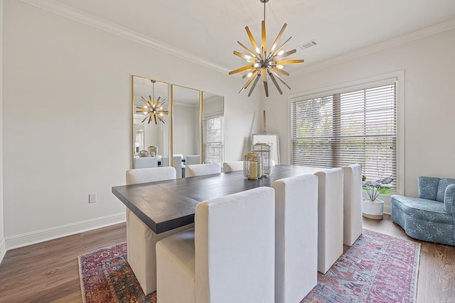 dining space with dark hardwood / wood-style flooring, an inviting chandelier, and crown molding