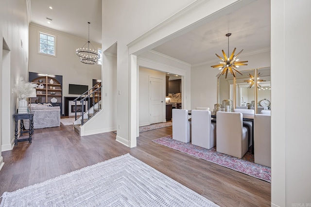 entrance foyer with a high ceiling, dark hardwood / wood-style flooring, and a notable chandelier