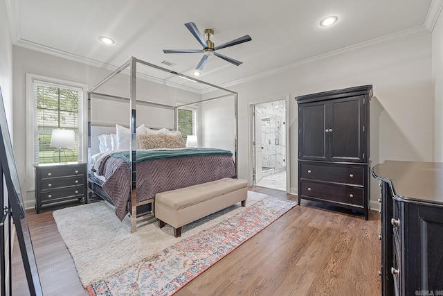 bedroom featuring hardwood / wood-style floors, connected bathroom, ceiling fan, and ornamental molding