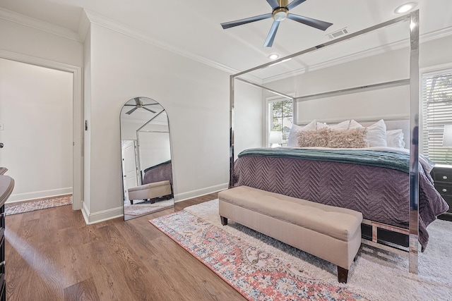 bedroom featuring ceiling fan, crown molding, and hardwood / wood-style flooring