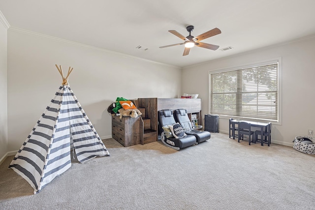 living area with ceiling fan, light colored carpet, and crown molding