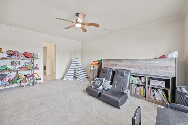 rec room with crown molding, carpet, and ceiling fan