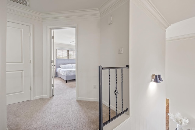 hallway with light carpet and ornamental molding