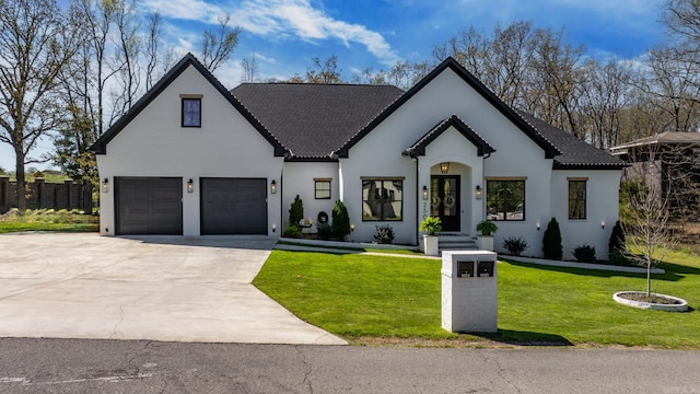 view of front of house with a garage and a front lawn