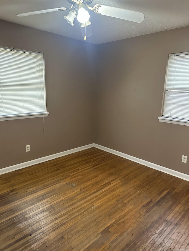 unfurnished room featuring a textured ceiling, dark hardwood / wood-style flooring, and ceiling fan