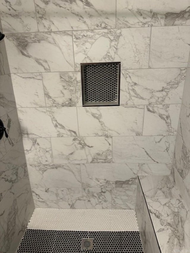 bathroom with a tile shower