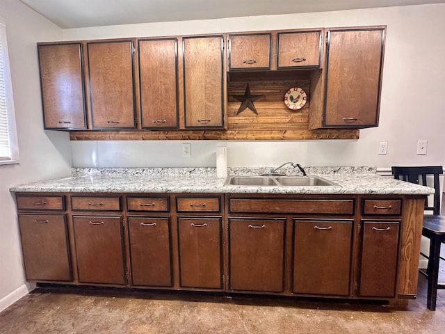 kitchen with dark brown cabinetry and sink