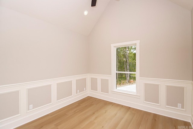 unfurnished room featuring light hardwood / wood-style flooring and high vaulted ceiling