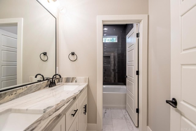 bathroom with vanity and tiled shower / bath combo