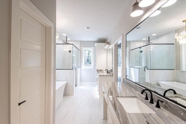 bathroom with vanity and independent shower and bath