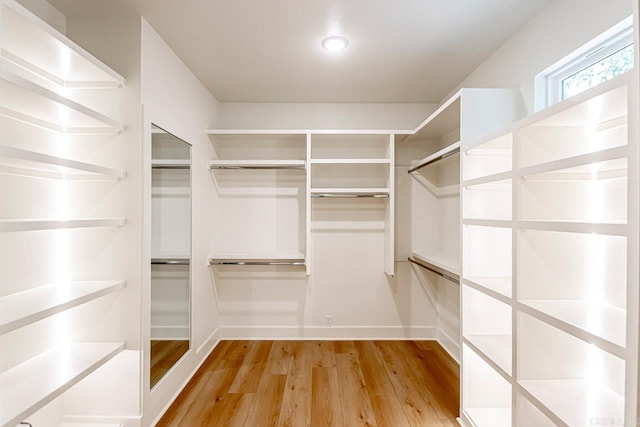 walk in closet featuring light hardwood / wood-style flooring