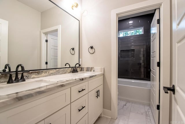 bathroom featuring vanity and tiled shower / bath