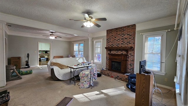 carpeted living room featuring a textured ceiling, a fireplace, and a wealth of natural light