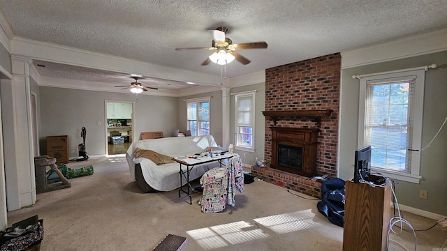 carpeted living room with ceiling fan, a fireplace, ornamental molding, and a textured ceiling