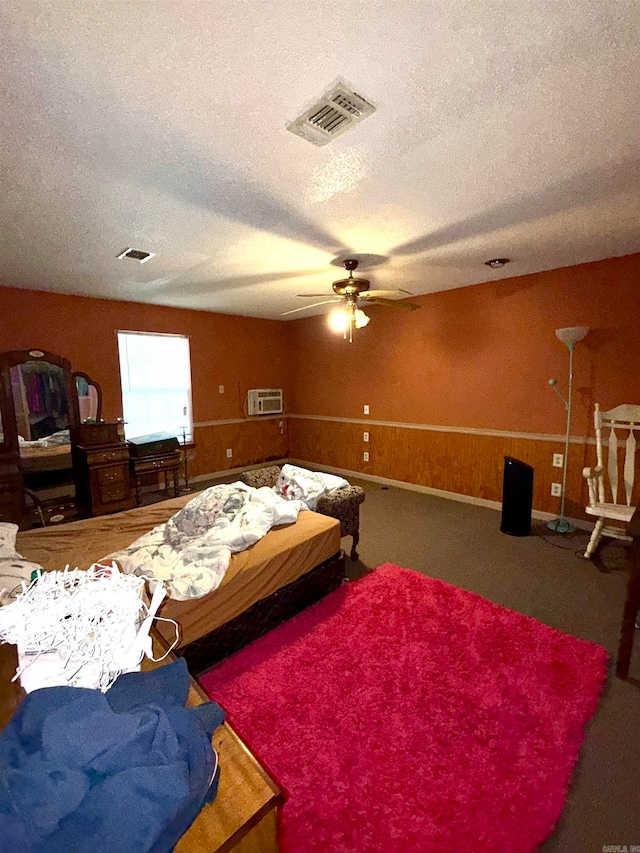 carpeted bedroom featuring a textured ceiling and ceiling fan