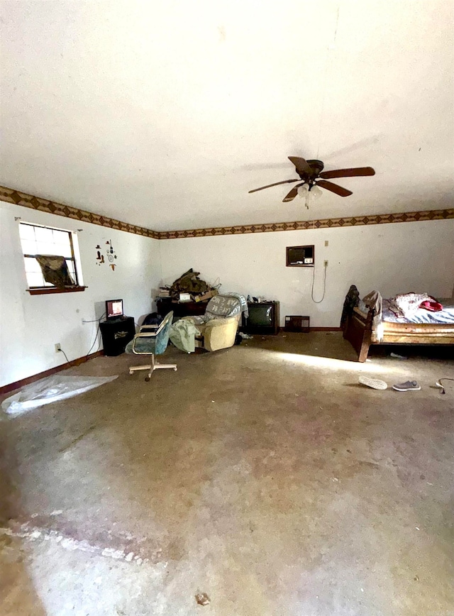 bonus room with ceiling fan and concrete flooring