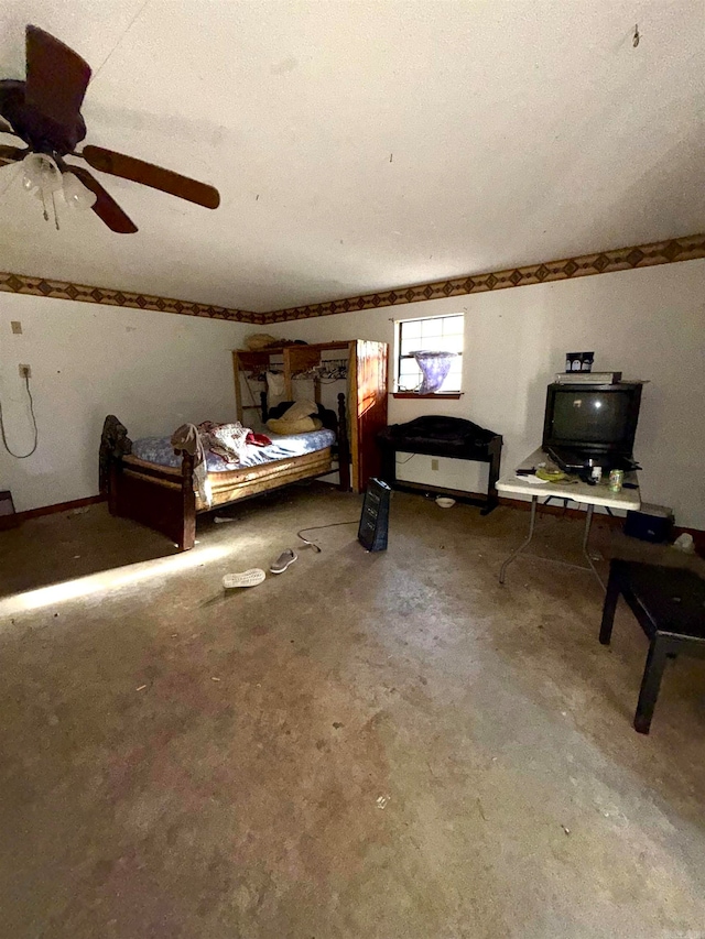 bedroom featuring ceiling fan, concrete floors, and a textured ceiling