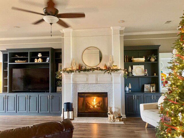 living room featuring ceiling fan, ornamental molding, and hardwood / wood-style flooring