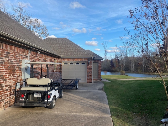 exterior space with a water view and a garage