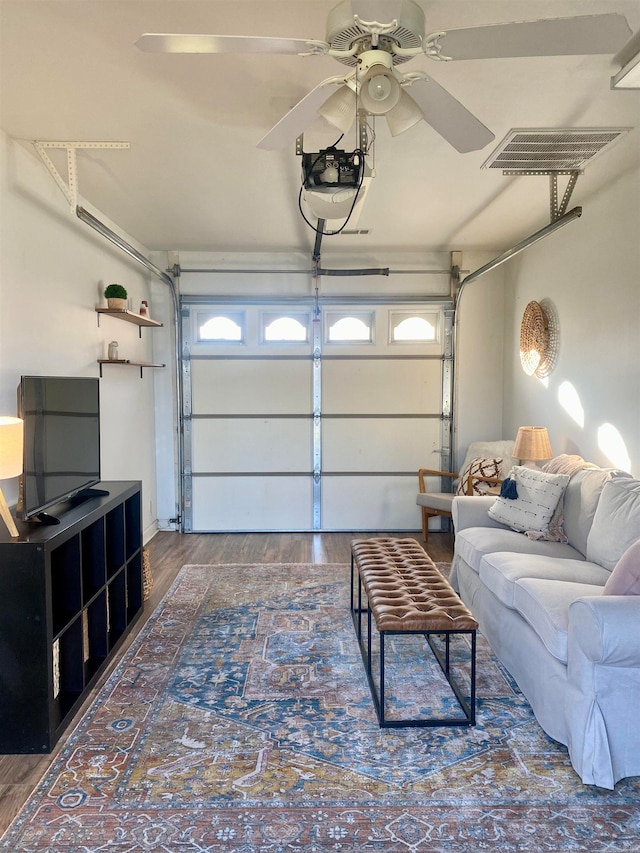 garage featuring ceiling fan and a garage door opener