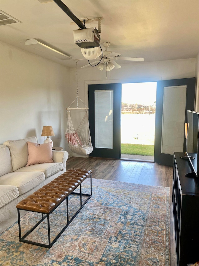 living room with wood-type flooring and ceiling fan