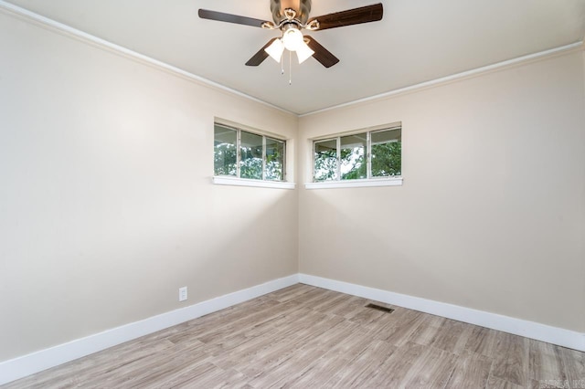 spare room featuring ceiling fan, light wood-type flooring, and crown molding