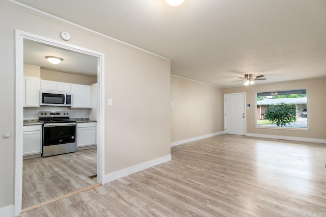 unfurnished living room featuring light hardwood / wood-style flooring, ceiling fan, and crown molding