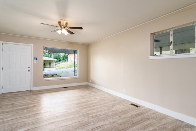 unfurnished room with crown molding, ceiling fan, and light hardwood / wood-style floors