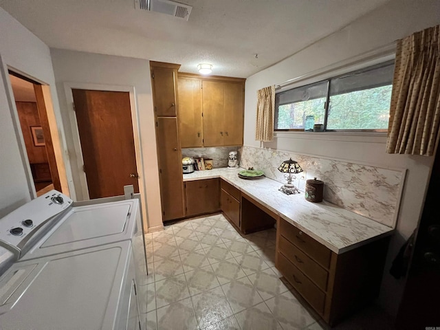 washroom featuring light tile patterned floors, a textured ceiling, and washing machine and dryer