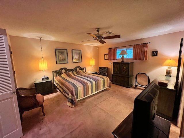 bedroom featuring ceiling fan and carpet