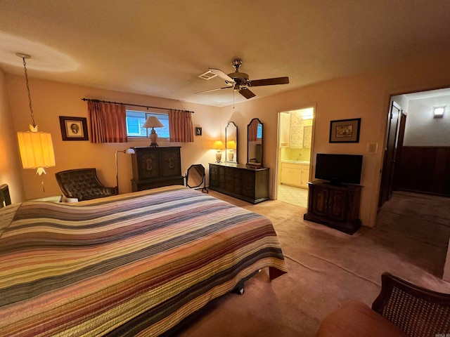 carpeted bedroom with connected bathroom and ceiling fan