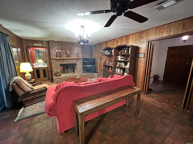 living room featuring wood walls and a textured ceiling