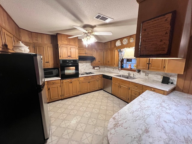 kitchen with black appliances, ceiling fan, backsplash, and a textured ceiling