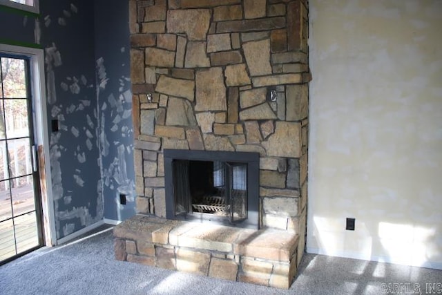 room details with carpet floors and a stone fireplace