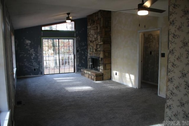 unfurnished living room featuring ceiling fan, carpet floors, a fireplace, and vaulted ceiling