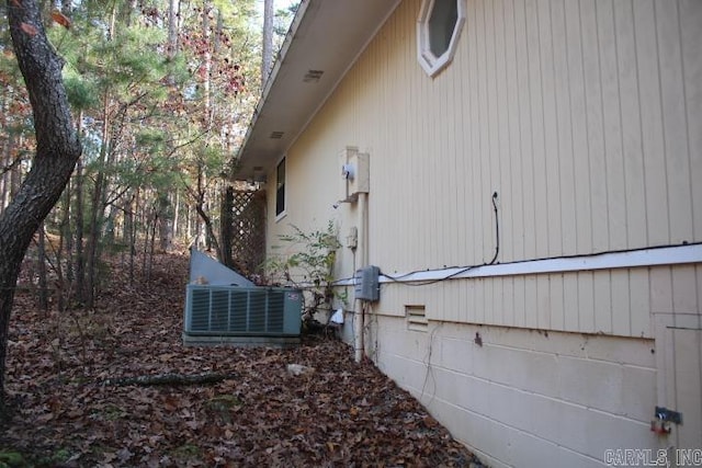 view of side of home with central air condition unit