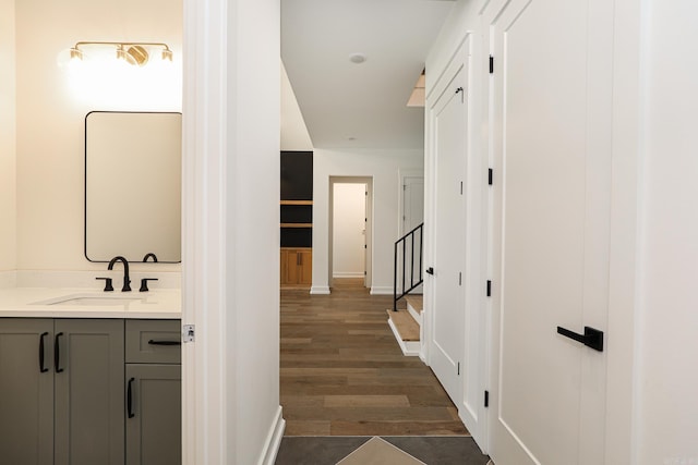 hall with dark hardwood / wood-style floors and sink