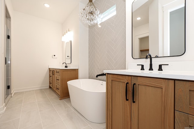 bathroom featuring vanity, tile patterned floors, a bathing tub, tile walls, and a notable chandelier